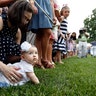 Evangeline Brienza, is held by her mother Elizabeth Brienza, of Alexandria, Va., at the Congressional Picnic at the White House