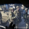 American army personnel gather at the University of Mosul during a battle with Islamic State militants in Mosul, Iraq, January 18, 2017