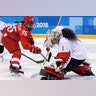 Goalie Shannon Szabados of Canada, deflects a shot by Russian Yekaterina Nikolayeva in their ice hockey game  at the 2018 Winter Olympics