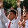 People watch news that North Korean leader Kim Jong Un signed an order to test launch an intercontinental ballistic rocket in Pyongyang, July 4