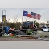 The Texas state flag and American flag wave over an area of debris left behind in the wake of Hurricane Harvey, Sunday, in Rockport, Texas