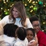 First lady Melania Trump is greeted by children in the East Room of the White House on Monday, Nov. 27.