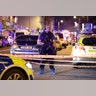 An armed police officer mans a cordon on the Seven Sisters Road at Finsbury Park where a vehicle struck pedestrians in London