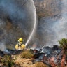 A member with Cal Fire fights a brush fire on a hillside in Burbank, September 2