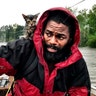 Robert Simmons Jr. and his kitten Survivor are rescued from floodwaters in New Bern, N.C., on Friday.