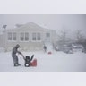 Gilberto Colin gets a head start on snowplowing his property during the middle of a snowstorm,  in Neptune, N.J., Thursday