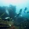 Divers swim at the USAT Liberty wreck, a boat that slipped off a beach and sunk during the eruption of the Mount Agung volcano in 1963