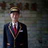 Kim Guan Huan, 60, a concierge, poses for a portrait at the entrance of the Koryo Hotel in Pyongyang, North Korea, October 23, 2014