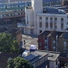 A forensic tent, center, stands next to a van, in white, at Finsbury Park in north London