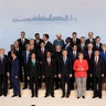 Participants pose for a group photo on the first day of the G-20 summit in Hamburg, Germany