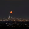The moon rising over the skyline of lower Manhattan on Saturday
