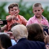 A boy gives gives a thumbs-up to U.S. President Donald Trump at the Congressional Picnic