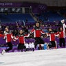 Canadian figure skaters celebrate winning the gold medal in the team event at the 2018 Winter Olympics