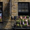 Pictures of Prince Harry and his fiancee Meghan Markle are seen in a pub window near Windsor Castle in Windsor, Britain, May 8, 2018