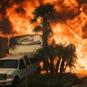 Flames consume a home on Via Arroyo as a wildfire rages in Ventura, California, Tuesday