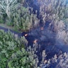 Lava flows over a road in the Puna District as a result of the eruption from Kilauea Volcano on Hawaii's Big Island, May 4, 2018