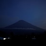 The full-moon is seen along with Mount Agung volcano, from Amed in Karangasem Regency, Bali, Indonesia, December 4