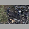 Firemen are shielded as they search through the debris scattered around the Grenfell Tower in London