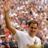 Switzerland's Roger Federer carries the trophy after defeating Croatia's Marin Cilic to win the Wimbledon men's singles title in London