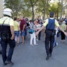 Police keep people back after a van crashed into a crowd of residents and tourists on Las Ramblas in Barcelona, August 17