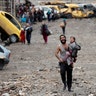 A man carries his daughter while walking from an Islamic State-controlled part of Mosul during a battle, March 4, 2017