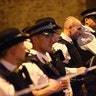 Police officers attend to the scene after a vehicle collided with pedestrians near a mosque in the Finsbury Park neighborhood of London