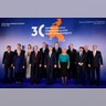 President Donald Trump and Polish President Andrzej Duda take part in a family photo at the Three Seas Initiative Summit in Warsaw