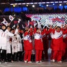 North and South Korean athletes wave flags during the closing ceremony at the 2018 Winter Olympics in Pyeongchang