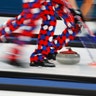 Norway's curlers sweep during a match against South Korea at the 2018 Winter Olympics