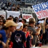 A Republican supporter holds up a sign supporting House Majority Whip Steve Scalise before the  annual Congressional Baseball Game