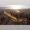 The sun sets on the playa at the annual Burning Man arts and music festival in the Black Rock Desert of Nevada, August 28