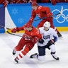 Russian athlete Pavel Datsyuk (13) battles with Troy Terry (23), of the U.S.