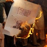 Protesters burn a picture of U.S. President Donald Trump at a protest in Islamabad, Pakistan, December 7