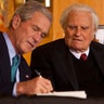 Former U.S. President George W. Bush signs a copy of his new book 