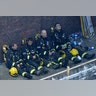 Firefighters take a break in battling the massive fire that raged in a high-rise apartment building in London