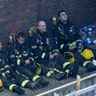 Firefighters take a break in battling the massive fire that raged in a high-rise apartment building in London