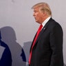 President Donald Trump casts shadows on the wall at the end of a joint press conference with Poland's President Andrzej Duda, in Warsaw