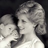 Prince Harry tries to hide behind his mother Princess Diana during a picture session at Marivent Palace on August 9, 1988