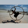 Kylie Webb of Santa Cruz, California spins inside a metal hoop on a roller disco floor at the Burning Man arts and music festival, August 28 