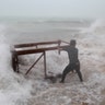 A man tries to salvage a table from his restaurant before the arrival of Hurricane Maria in Punta Cana, Dominican Republic, Wednesday