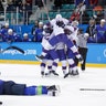 Norway players celebrate after winning their qualification round men's ice hockey game against Slovenia at the Winter Olympics