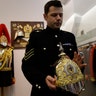 Corporal of the Horse, John Brophy shows off a helmet designed by the husband of Queen Victoria, at the units barracks in London, May 9, 2018