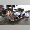 Neighbors use their personal boats to rescue flooded Friendswood residents Sunday, in Friendswood, Texas