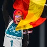 Laura Dahlmeier waves the German flag as she wins the gold medal in the women's 10-kilometer biathlon pursuit at the 2018 Winter Olympics