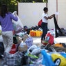 People go through clothing and other supplies donated for victims of the apartment fire in London