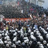 German riot police stand in front of protesters during the demonstrations at the G20 summit in Hamburg, Germany, July 6
