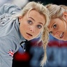 Anna Sloan and Vicki Adams of Britain sweep during their curling match against athletes from Russia at the 2018 Winter Olympics