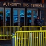A police officer stands guard in front of Port Authority Bus Terminal in New York City, Monday