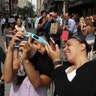 People watch the solar eclipse on 5th Avenue in New York