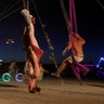 A participant rides a swing at the Burning Man arts and music festival in the Black Rock Desert of Nevada, August 28